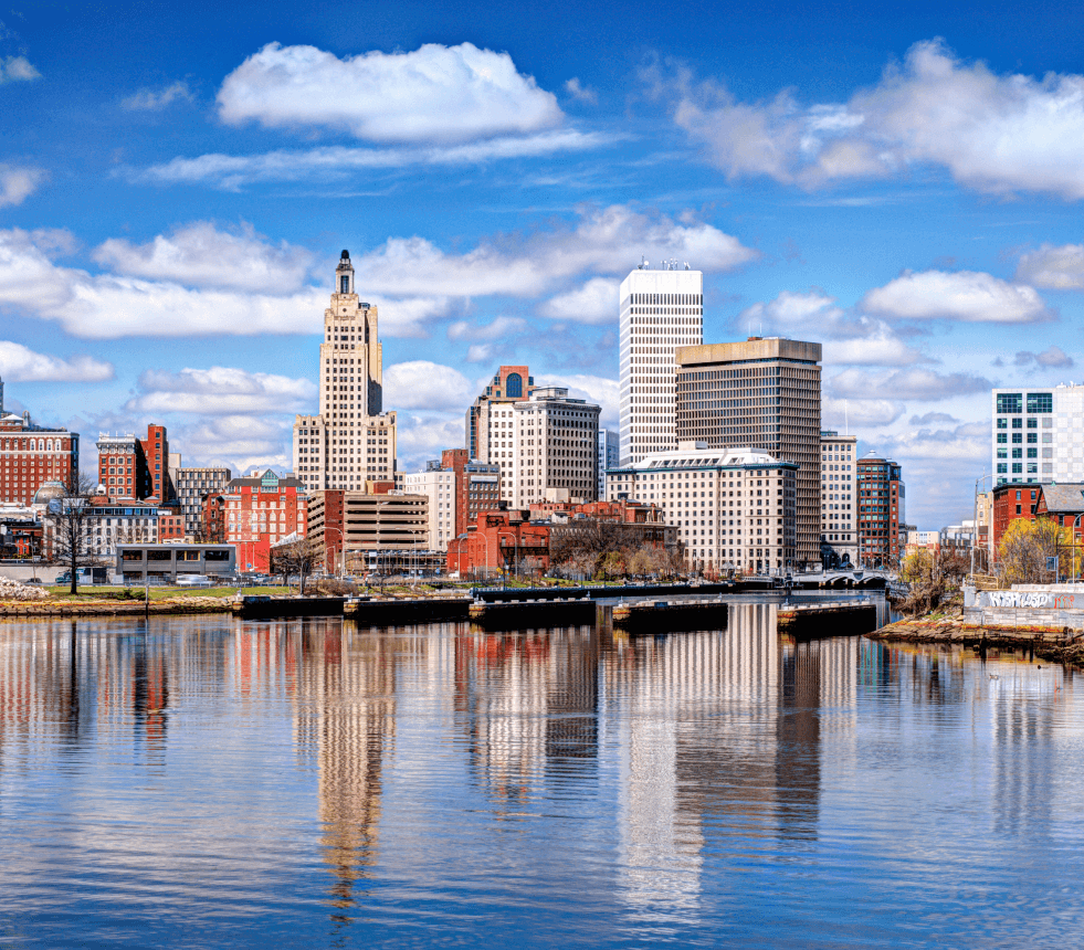 A city skyline with buildings and water.