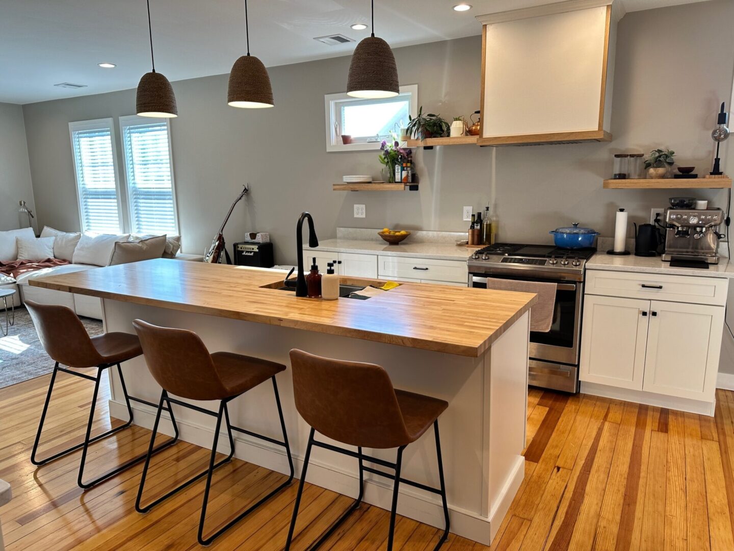 A kitchen with wooden floors and white walls.