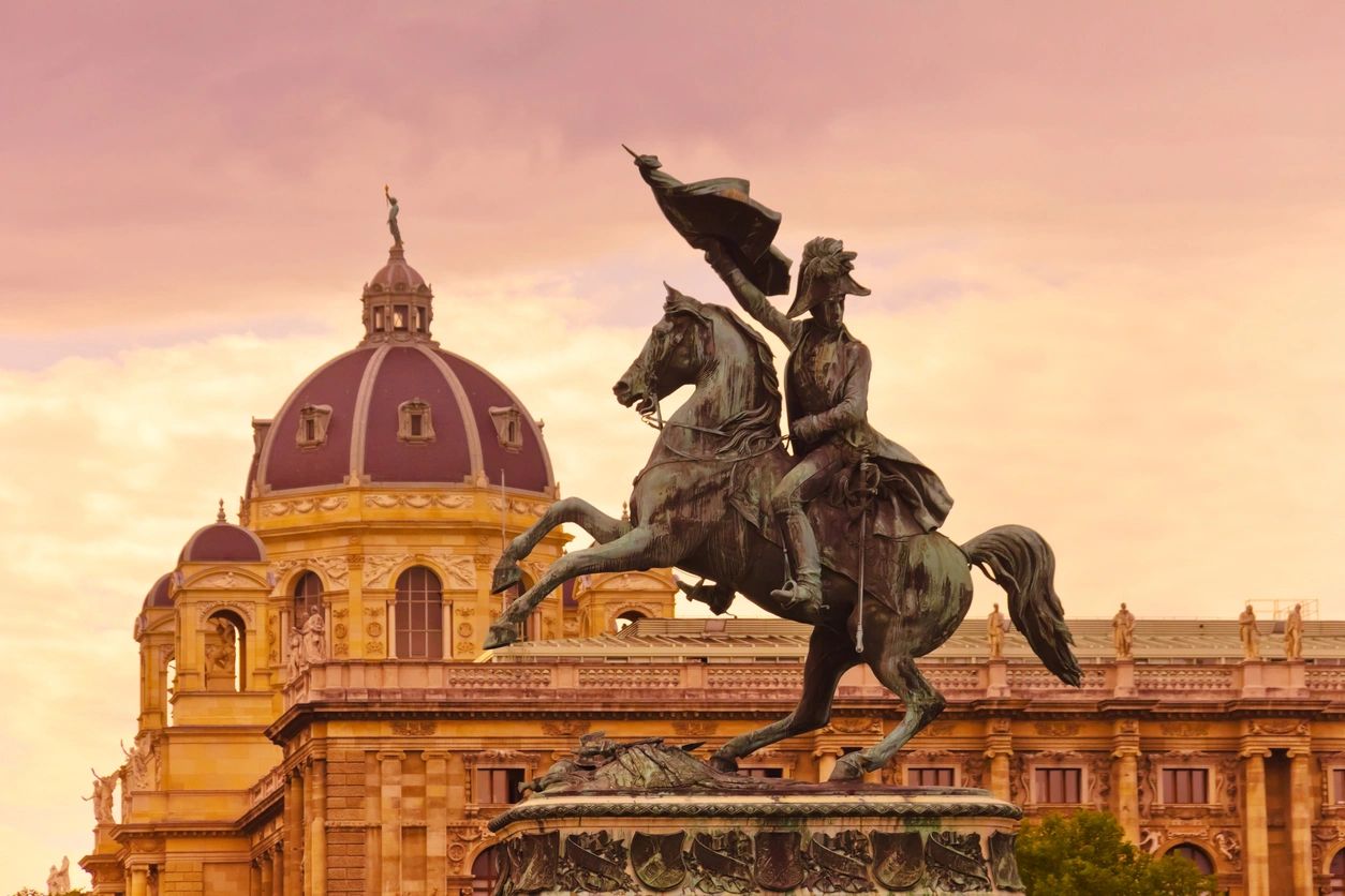 A statue of a man on horseback in front of a building.